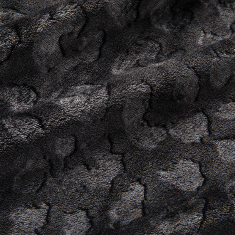 Close-up of a dark gray, textured fabric with a subtle animal print pattern and soft, velvety surface—reminiscent of the luxurious feel of the Embossed Plush Oversized Throw Blanket.