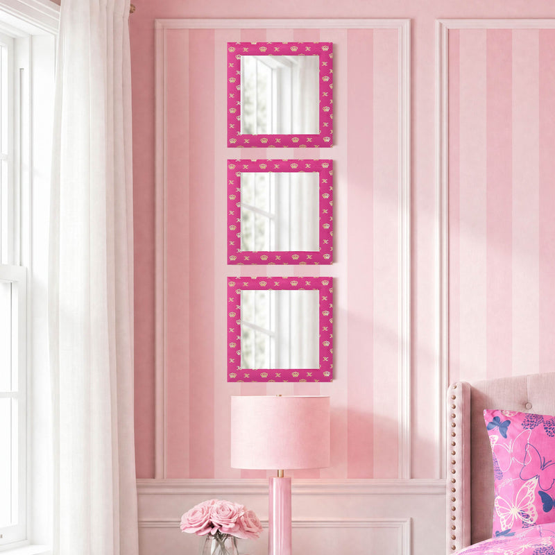 Three Velour Crown Foil Print Hot Pink with Gold Foil 12 in x 12 in mirrors hang vertically on a pink-striped wall above a light pink lamp and pink roses, with part of a pink bed and butterfly pillow visible.