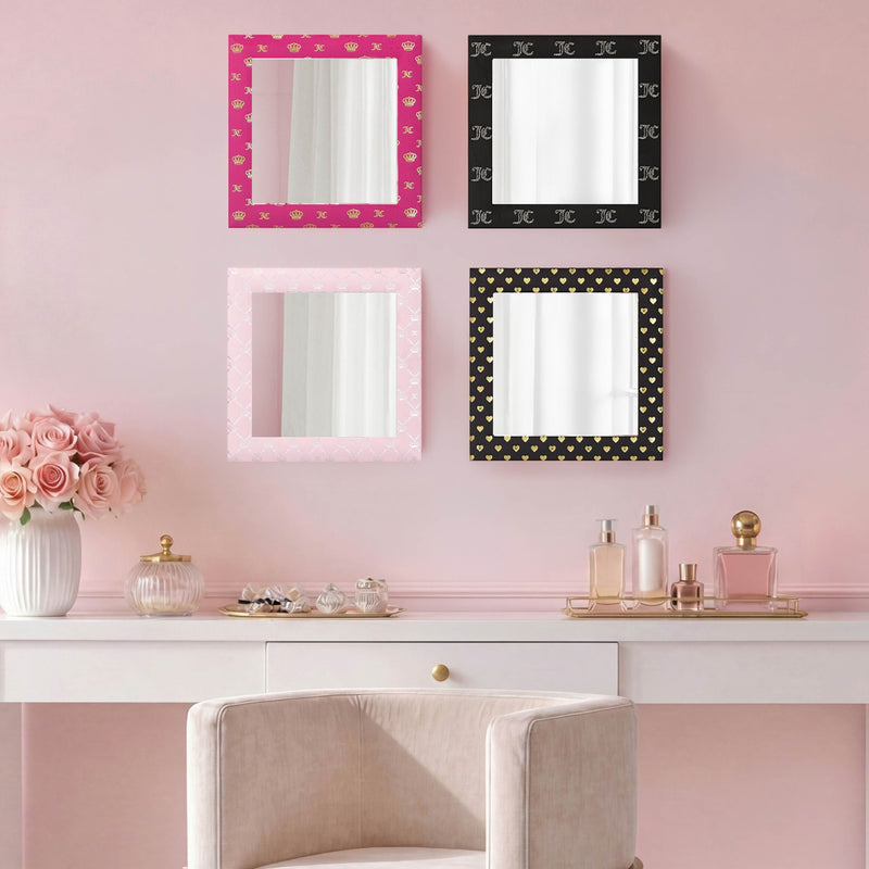 A vanity with a white chair sits against pink walls. Above the desk, the Velour Crown Foil Print Hot Pink with Gold Foil 3-Piece 12 in x 12 in Decorative Mirror Set creates an elegant and colorful focal point. Vases of pink roses and perfume bottles are arranged on the ready-to-hang vanity, resulting in a charming and refined space.
