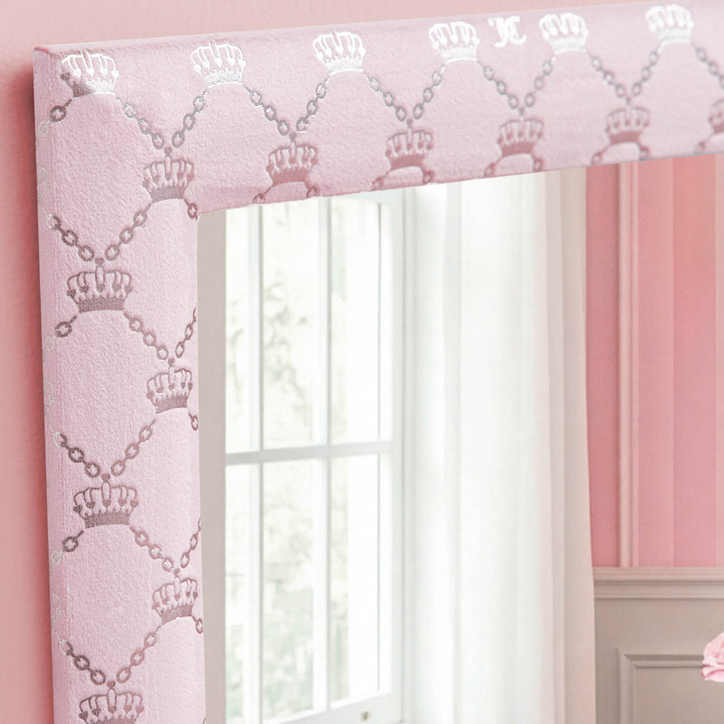A close-up of the Velour Lattice Crown Foil Print 3-Piece Decorative Mirror Set showcases its pink velour frame adorned with a lattice pattern of silver crowns and delicate pearl accents. The mirror's reflection reveals a bright window and part of a pale wall with white trim, making this set an elegant choice for wall decor.