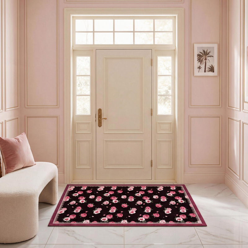 Finley Washable Rug, 2′ x 4′, a rectangular, ultra-soft machine-washable rug with a dark floral pattern of pink roses centered in a light-colored entryway.