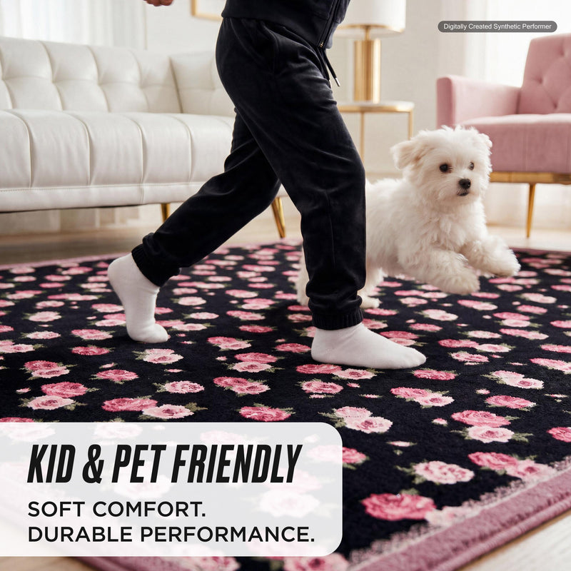 A child in socks and a small white dog run across a Finley Washable Rug, 2′ x 6′, an ultra-soft black runner with a pink floral pattern and text reading: Kid & pet friendly, soft comfort, durable performance.