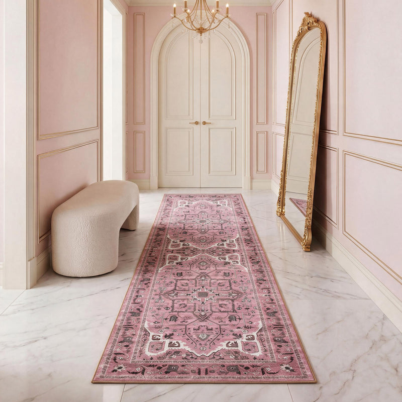 Finley Washable Rug, 2′ x 6′ in a long runner style featuring an ultra-soft, distressed pink and gray floral pattern centered in a marble-floored hallway.