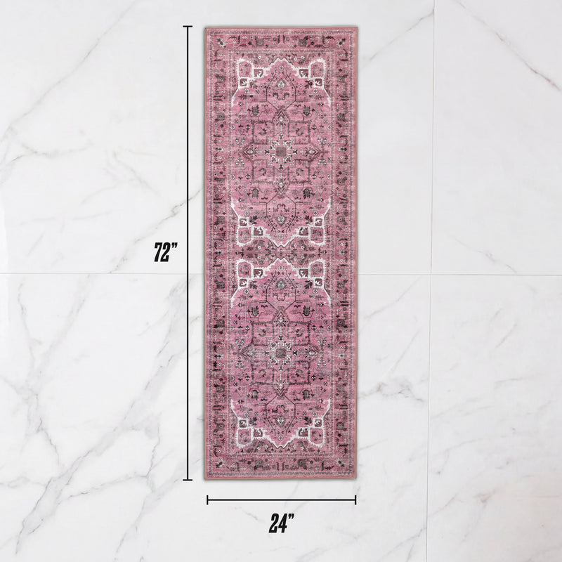 Finley Washable Rug, 2′ x 6′, an ultra-soft runner with a faded pink and grey traditional medallion pattern, shown on a white marble floor.