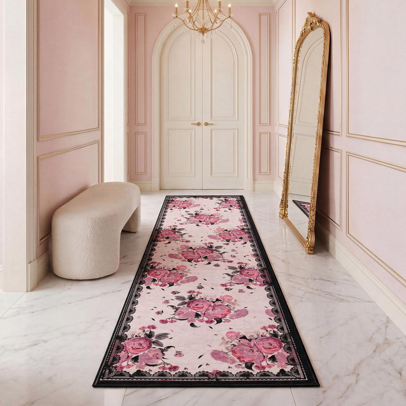 Ultra-soft Finley Washable Rug, 2′ x 6′, featuring a pink floral pattern and a black border, centered in a hallway.