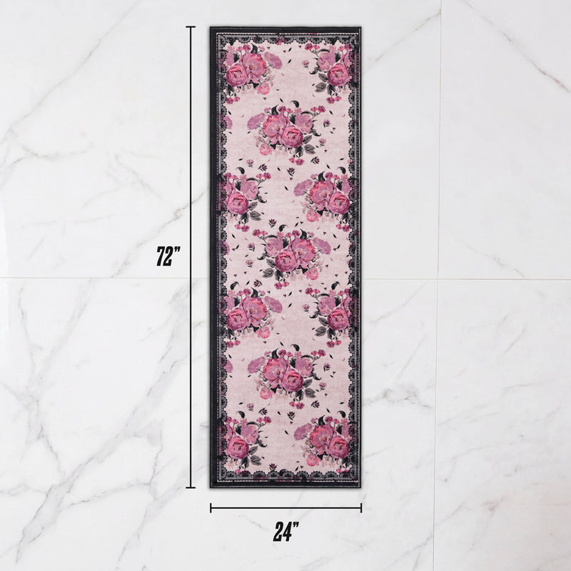 Finley Washable Rug, 2′ x 6′, an ultra-soft rectangular runner featuring a pink and black floral pattern with a dark lace-style border.