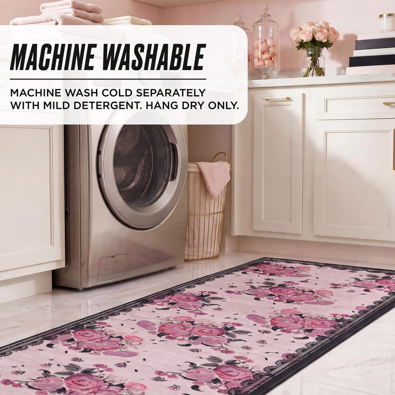 Finley Washable Rug, 2′ x 6′, featuring a pink floral pattern with a dark border in a laundry room, with overlaid text: Machine wash cold separately with mild detergent. Hang dry only.
