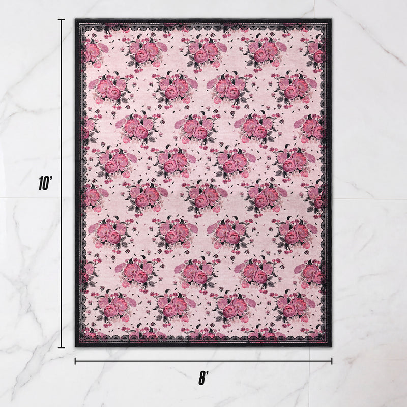 Finley Washable Rug, 8′ x 10′, an ultra-soft rectangular area rug with a repeating pattern of pink roses on a pale pink background, framed by a dark floral border.