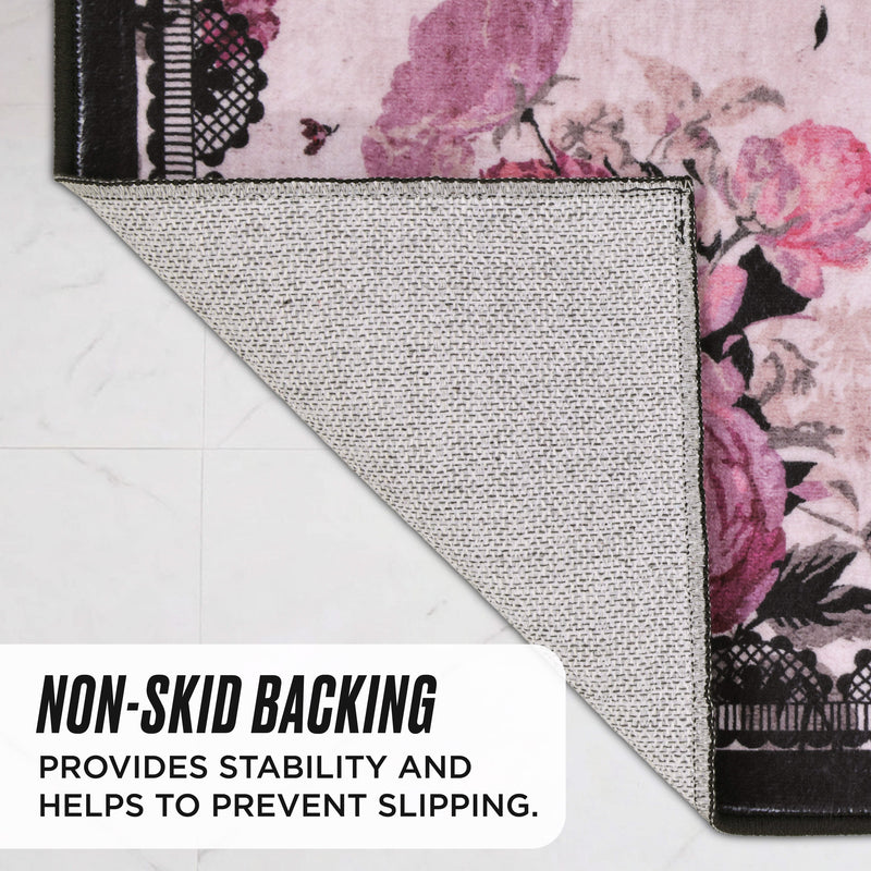 The Finley Washable Rug, 8′ x 10′ is folded to show its floral pattern and textured, non-skid backing, which provides stability and helps prevent slipping.