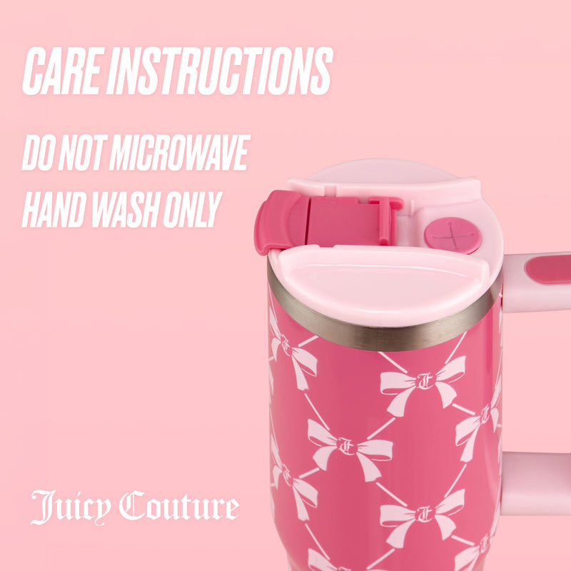 The Jetsetter Tumbler with Handle, Straw & Topper, 30 oz by Juicy Couture features a pink design with a bow pattern and is made of stylish stainless steel. The tumbler displays care instructions: Do not microwave. Hand wash only.