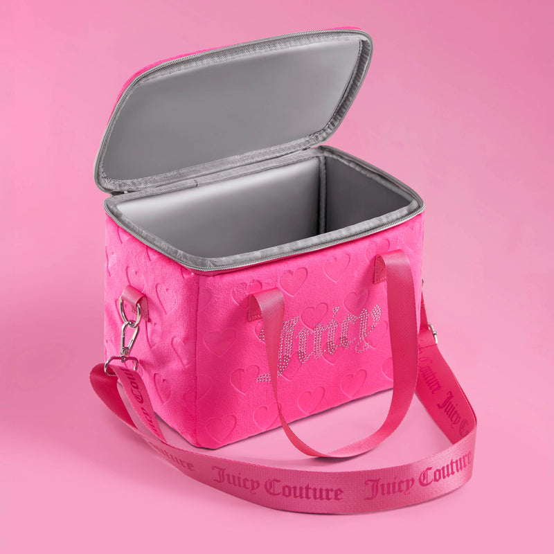 The Chill Couture Cooler Bag is a stylish pink insulated lunch tote featuring heart patterns, an open gray-lined interior, pink handles, and a detachable pink strap with Juicy Couture branding, all set against a light pink background.