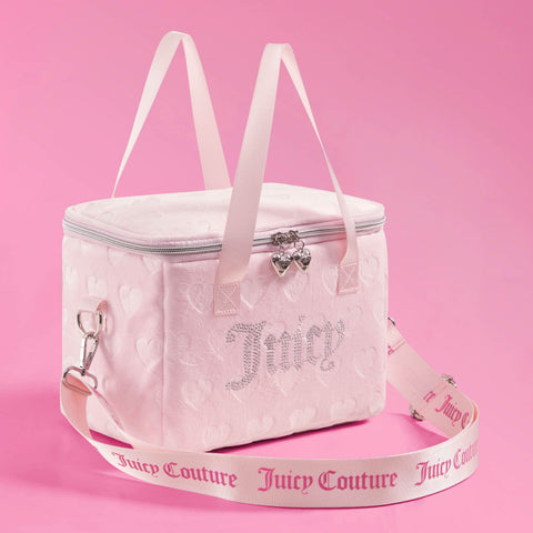 The Chill Couture Cooler Bag is a light pink Juicy Couture lunch tote featuring heart patterns, a silver zipper, jeweled Juicy lettering, double handles, and a removable strap with “Juicy Couture” text, all showcased against a pink background.