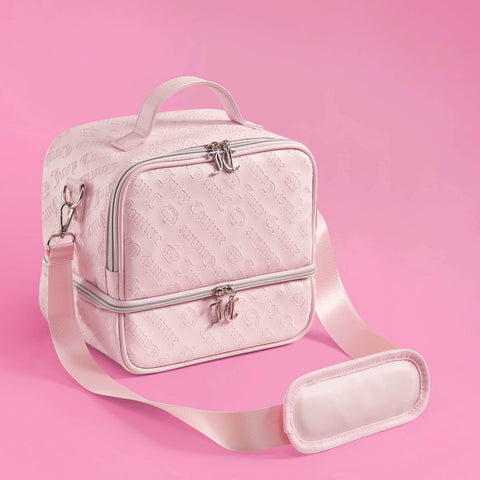 A light pink Double Zip Chill Cooler Bag by Juicy Couture features embossed logos, a top handle, double zip closures, and an adjustable shoulder strap, set against a solid pink background. This chic insulated tote keeps your meals fresh in style.