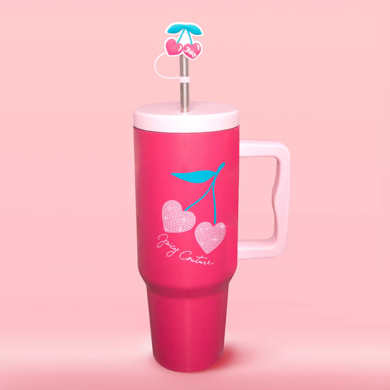 A tall pink GoGlam Rhinestone Tumbler with a handle, featuring insulated stainless steel construction and decorated with cherries and the phrase “Joy Creator.” It comes with a white lid and a reusable straw topped with a cherry-shaped accent. The background is solid light pink.