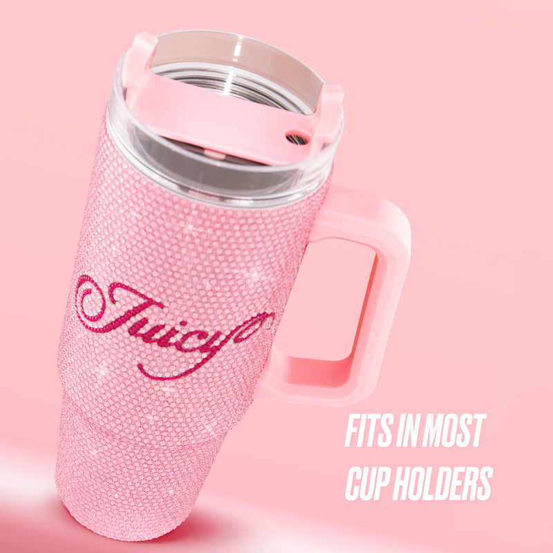 A large pink BlingSip Rhinestone Tumbler with Handle, Straw, and Topper sits on a pink background, adorned with sparkling rhinestones and “Juicy” written in script. Text reads: Fits in most cup holders. This insulated stainless steel tumbler keeps your drinks at the perfect temperature while adding a touch of glamour to your day.