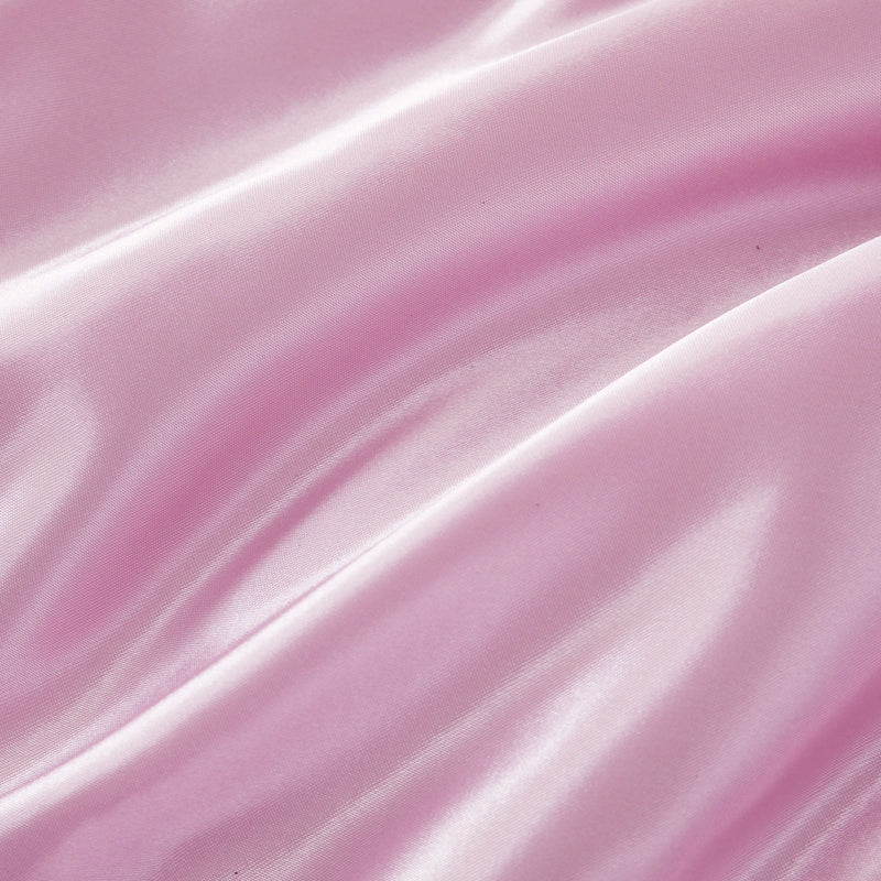 Experience a luxurious look and feel with the Solid Satin Down Alternative Comforter—crafted from shiny, light pink satin fabric featuring soft folds, a smooth texture, and gentle highlights that reflect light, this comforter delivers all-season warmth with an elegant touch.