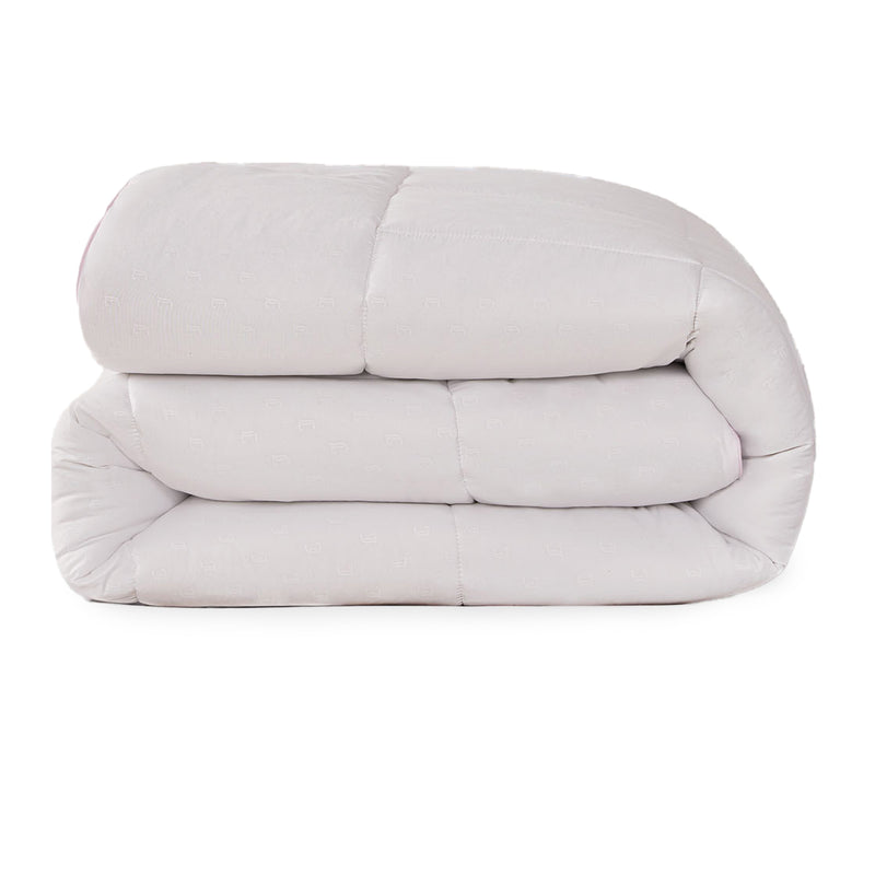 A neatly folded, thick, light-colored Embossed J Down Alternative Comforter by Juicy Couture is stacked against a white background.