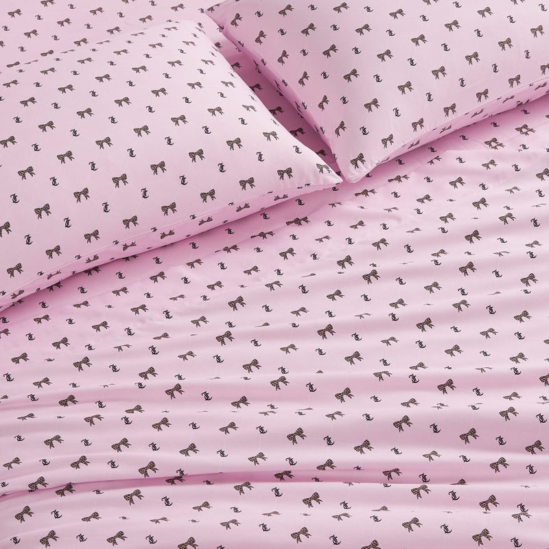 Introducing the Printed Microfiber Sheet Set—pink bed sheets and pillowcases adorned with a repeating pattern of small brown horse illustrations, expertly crafted from soft microfiber for added comfort and style.