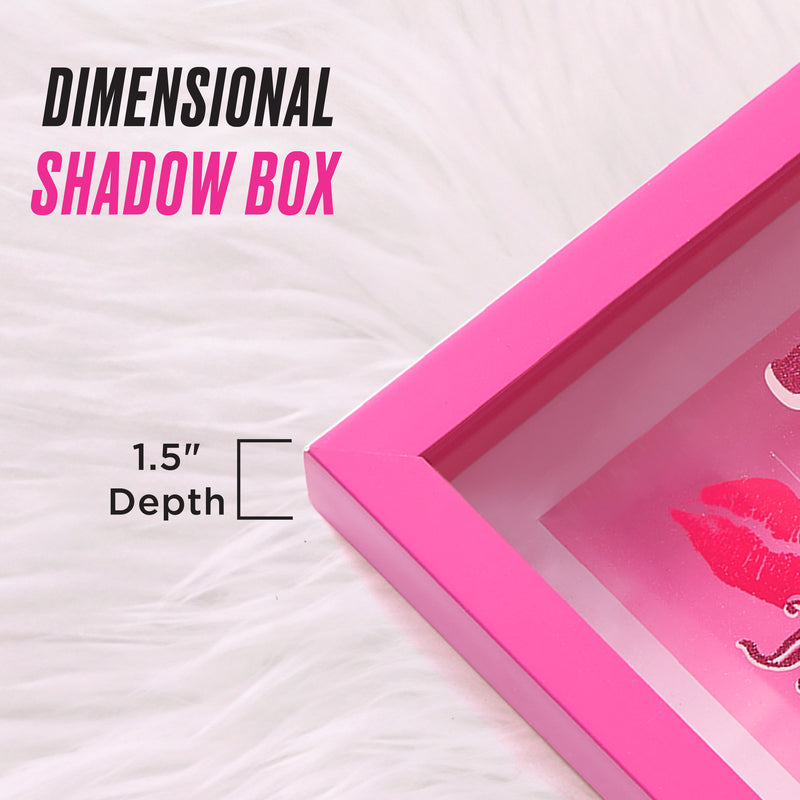 A 12″ x 16″ Shadow Box Wall Art with a chic pink frame and a 1.5-inch depth is displayed on a white fur surface. Bold text stating “DIMENSIONAL SHADOW BOX” and an arrow draw attention to the frame’s stylish dimensional design, making it a perfect addition of fashion-inspired wall art to any space.