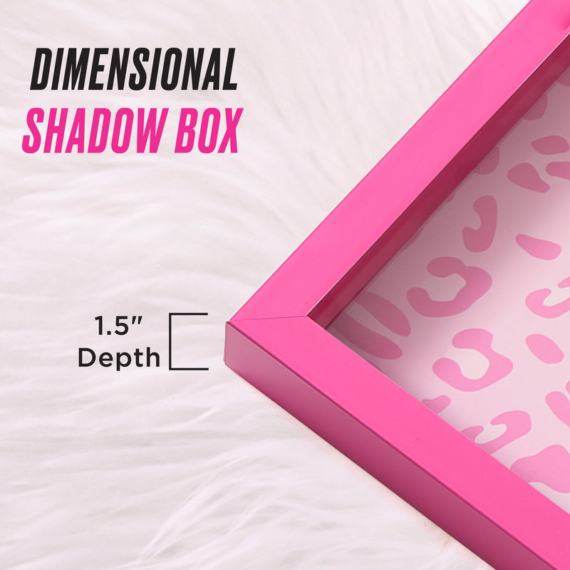 A pink Shadow Box Wall Art, 14″ x 14″ with a 1.5″ depth is displayed on a white fur surface, featuring a pink leopard print background reminiscent of Juicy Couture wall art. Text reads “Dimensional Shadow Box” and “1.5 Depth,” making it the perfect fashion-inspired artwork for any stylish space.