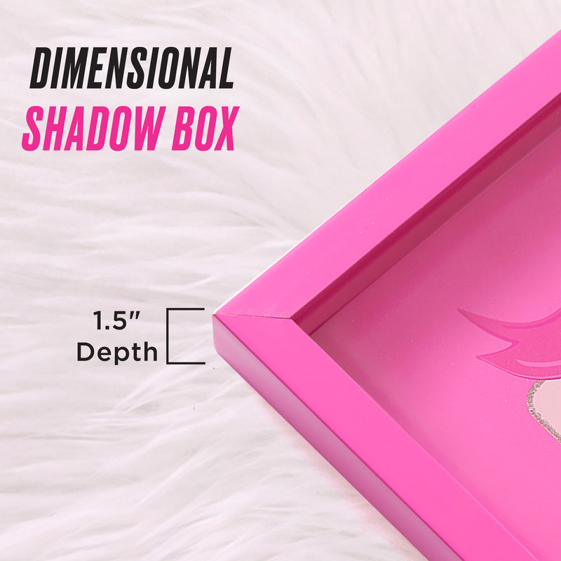 Close-up of a pink Shadow Box Wall Art, 12″ x 16″, featuring text that reads “Dimensional Shadow Box” and “1.5 Depth” on a white, fluffy background—perfect for showcasing shadow box art or adding fashion-inspired artwork to your space.