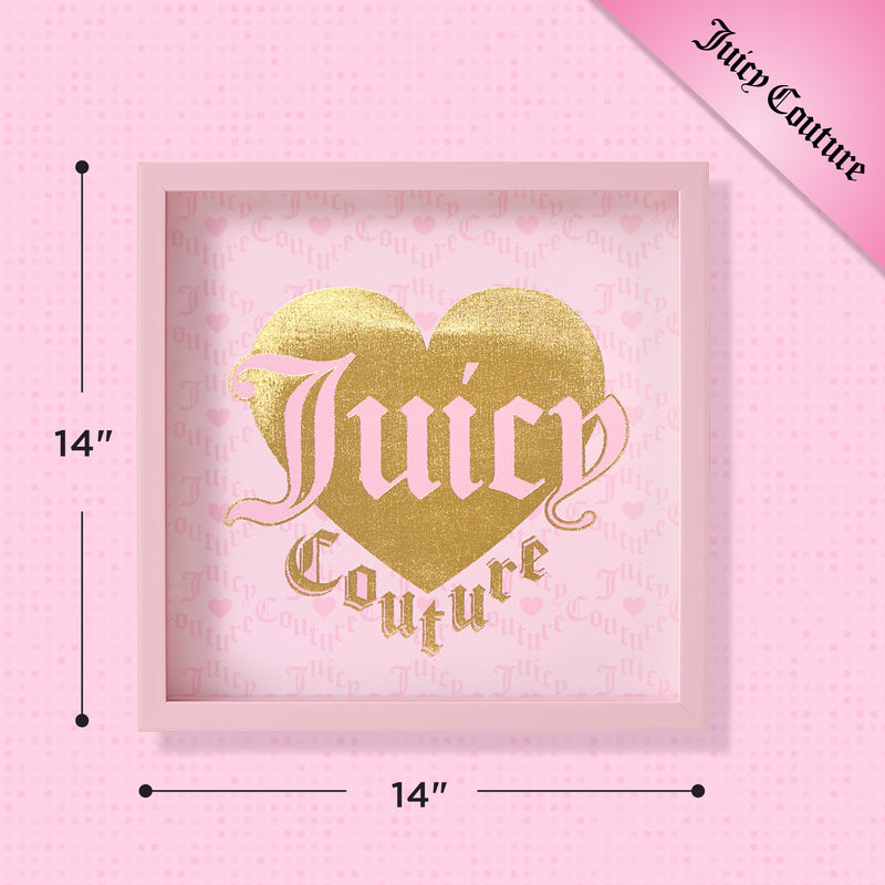 A 14″ x 14″ Shadow Box Wall Art featuring a pink frame, fashion-inspired design with a gold heart, and bold Juicy Couture lettering on a pink background. The iconic brand name also appears in the top right corner.