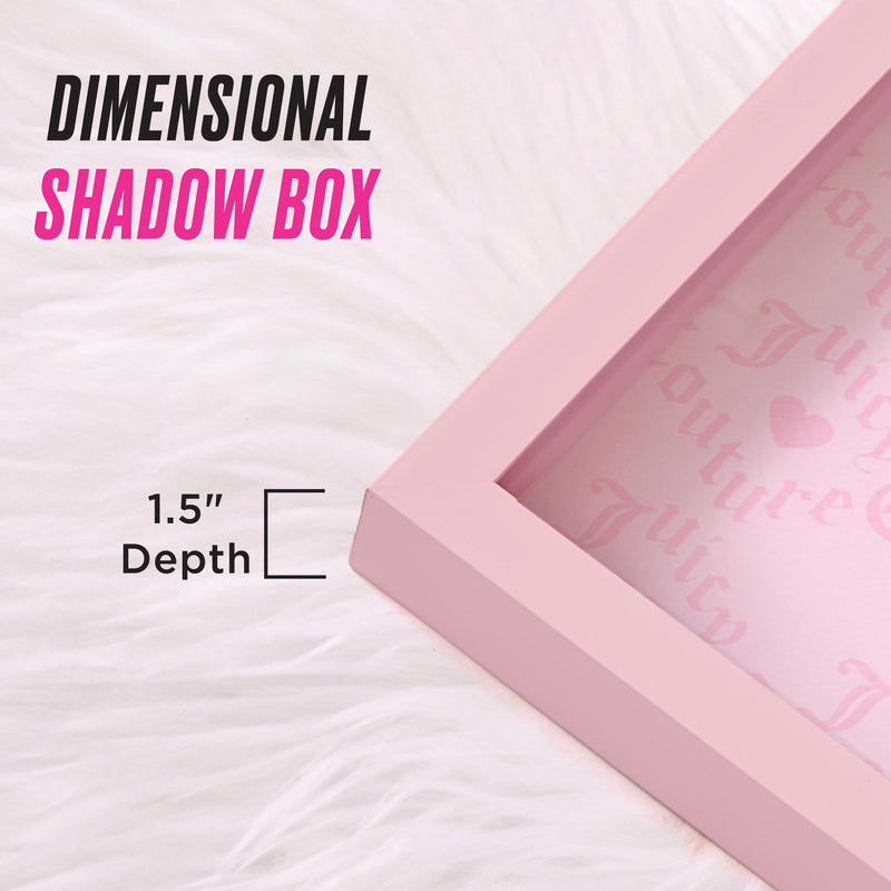 A chic and elegant Shadow Box Wall Art, 14″ x 14″, with a 1.5″ depth is displayed on white fur. The image features the text “DIMENSIONAL SHADOW BOX” and “1.5 Depth,” while faint pink decorative lettering inside the box adds a fashionable touch—making it the perfect artwork for any stylish room.