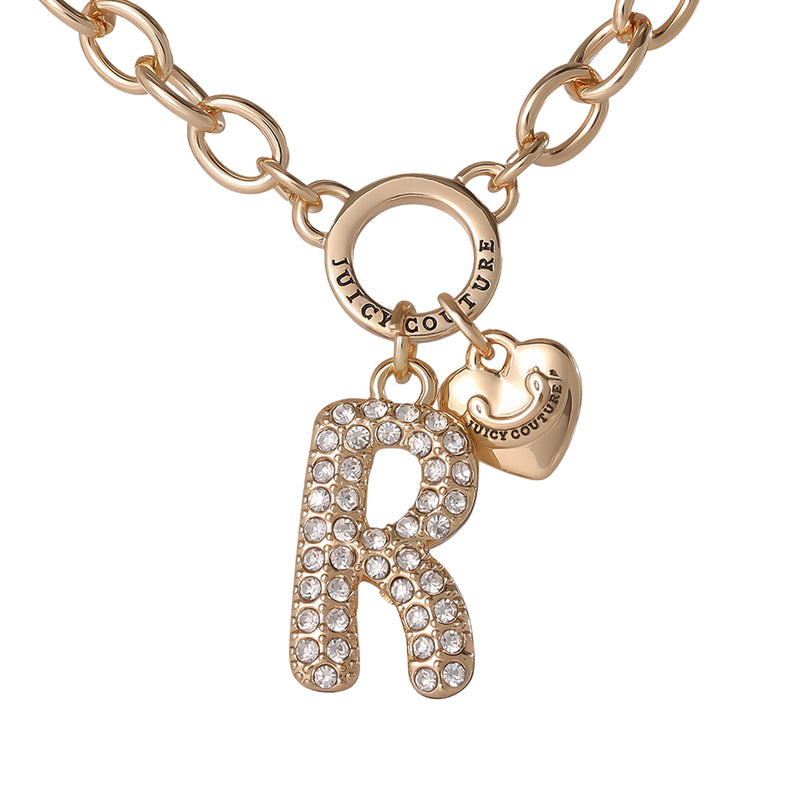 Introducing the Bubble Initial Necklace, Letter R—a gold chain necklace featuring a crystal-studded bubble letter “R” pendant and a petite engraved heart charm. Both charms dangle from a circular ring stamped with Juicy Couture, making this the ideal personalized jewelry accessory for anyone who loves the Y2K aesthetic.