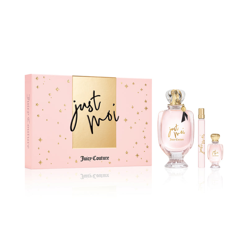 The Just Moi 3 Piece Fragrance Gift Set is presented in a vibrant pink and gold box and includes a full-size Eau de Parfum, a mini bottle, and a travel spray—all elegantly displayed against a white background. Experience the feminine scent of Just Moi by Juicy Couture with this beautifully packaged collection.