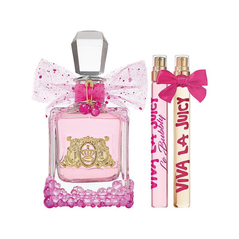 The Viva La Juicy Le Bubbly 3 Piece Fragrance Gift Set includes a pink Juicy Couture perfume bottle with a jeweled base, pink bow, and gold emblem, alongside two pink spray vials labeled Viva La Juicy Le Bubbly Eau de Parfum.