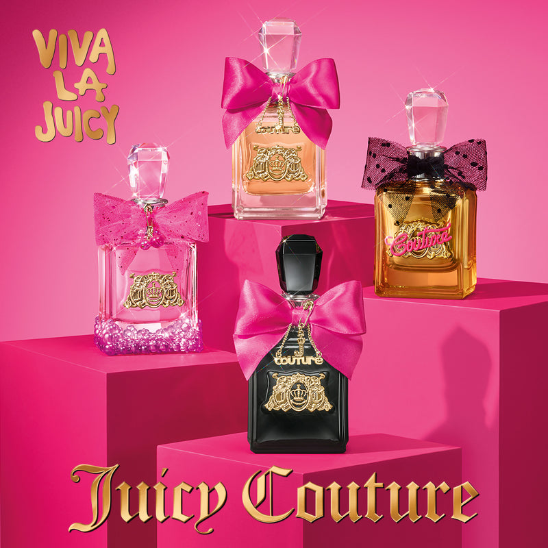 The Viva La Juicy 4 Piece Fragrance Discovery Gift Set features four mini eau de parfum bottles adorned with pink bows, displayed on vibrant pink platforms with “Viva La Juicy” and “Juicy Couture” in gold lettering against a bold pink background. This charming set is perfect for sampling each scent or taking your favorite travel-size perfume wherever you go.