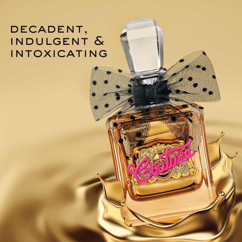 A mini Viva La Juicy eau de parfum bottle, adorned with a black polka-dot bow and gold Couture label, sits in a splash of gold liquid. Text reads: Decadent, Indulgent & Intoxicating.