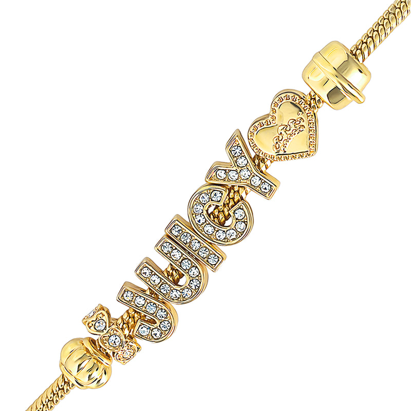 The Logo Charm Bracelet features the word “Juicy” spelled out in crystal-studded letters, accented with a heart charm, a bow charm, and gold clasp details—this bold Y2K piece is unforgettable statement jewelry.