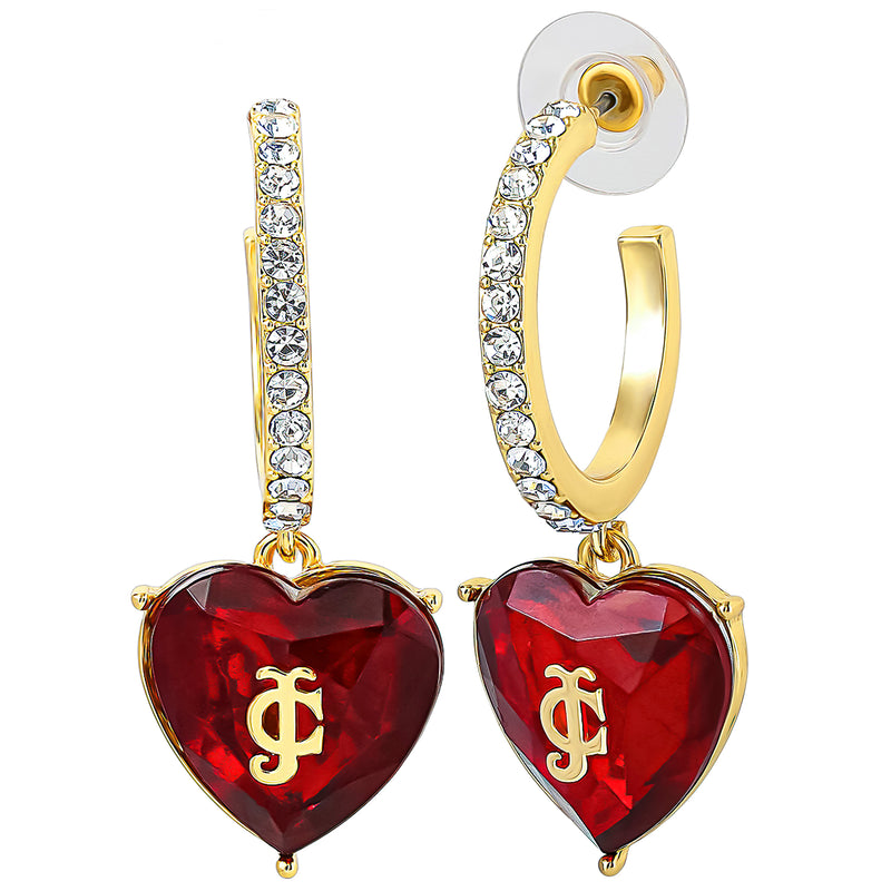 Gold hoop earrings adorned with clear crystals and red heart-shaped pendants, each accented by a gold JC logo at the center. The Heart Charm Hoop Earrings from Juicy Couture are completed with clear plastic backings, making them a perfect addition to any heart jewelry collection.