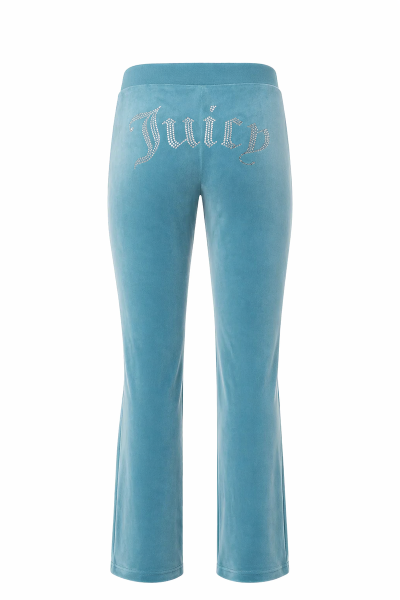 The OG Big Bling Velour Track Pants feature a luxe Y2K vibe, with blue velour fabric and "Juicy" spelled out in rhinestones across the seat—an iconic throwback look from the back.