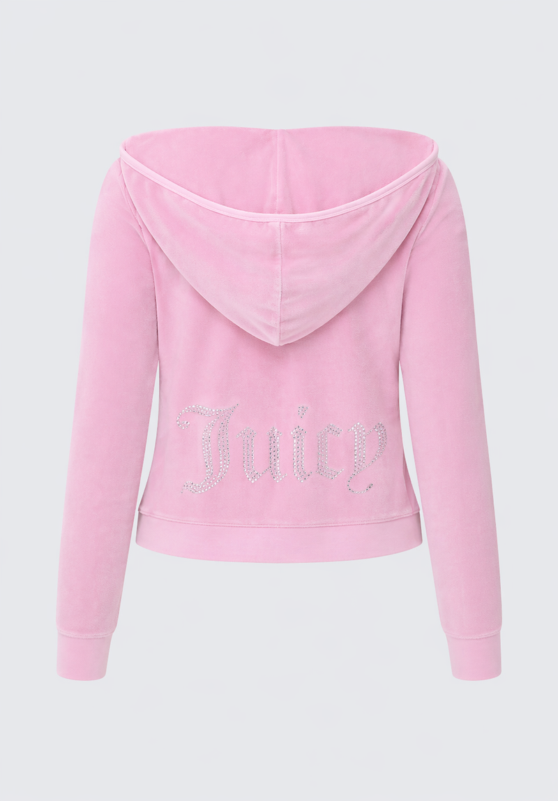 The Big Bling Washed Terry Hoodie is a light pink zip-up hoodie with a hood and long sleeves, featuring "Juicy" in large sparkly rhinestone letters on the back for a glamorous look.