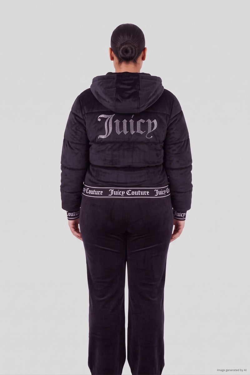 Back view of a person wearing a black Velour Puffer Coat with a large crystal logo on the back and matching velour pants.