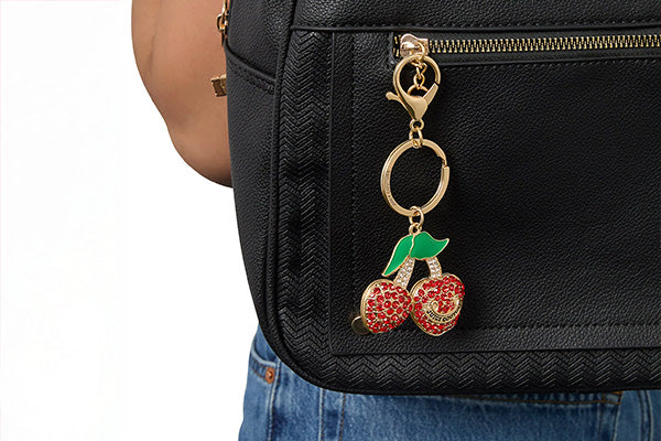 Black bag with a cherry keychain attached