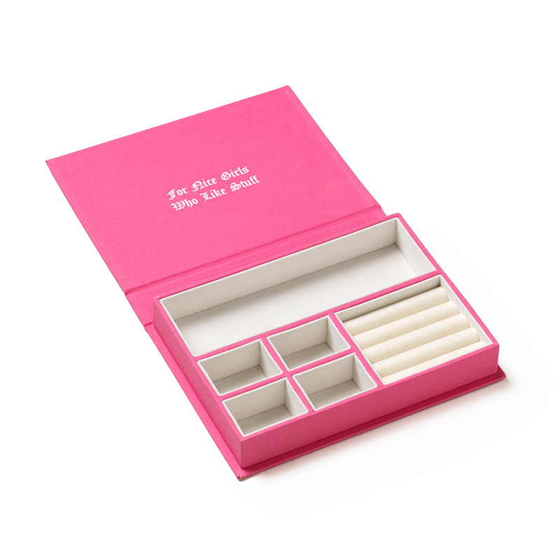 The Juicy Couture x Printworks Jewelry Box features a pink design with compartments, an open lid, and “For Nice Girls Who Like Stuff” printed in white on the inside cover—perfect for storing all your favorite treasures.