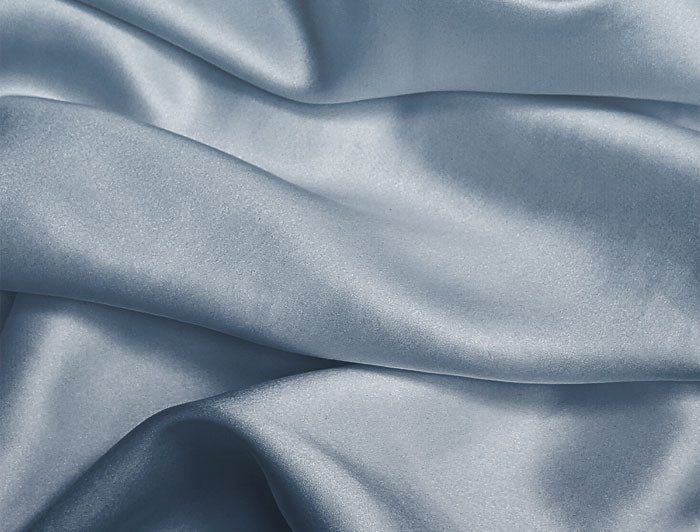 Close-up of blue satin fabric with folds