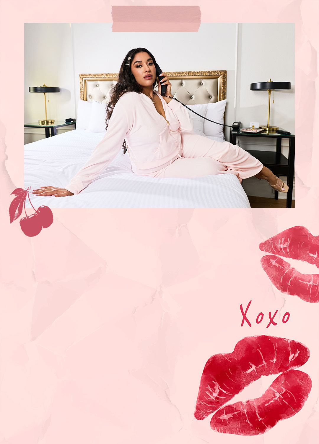 Woman in a pink Juicy Couture tracksuit sitting on a bed with a pink background