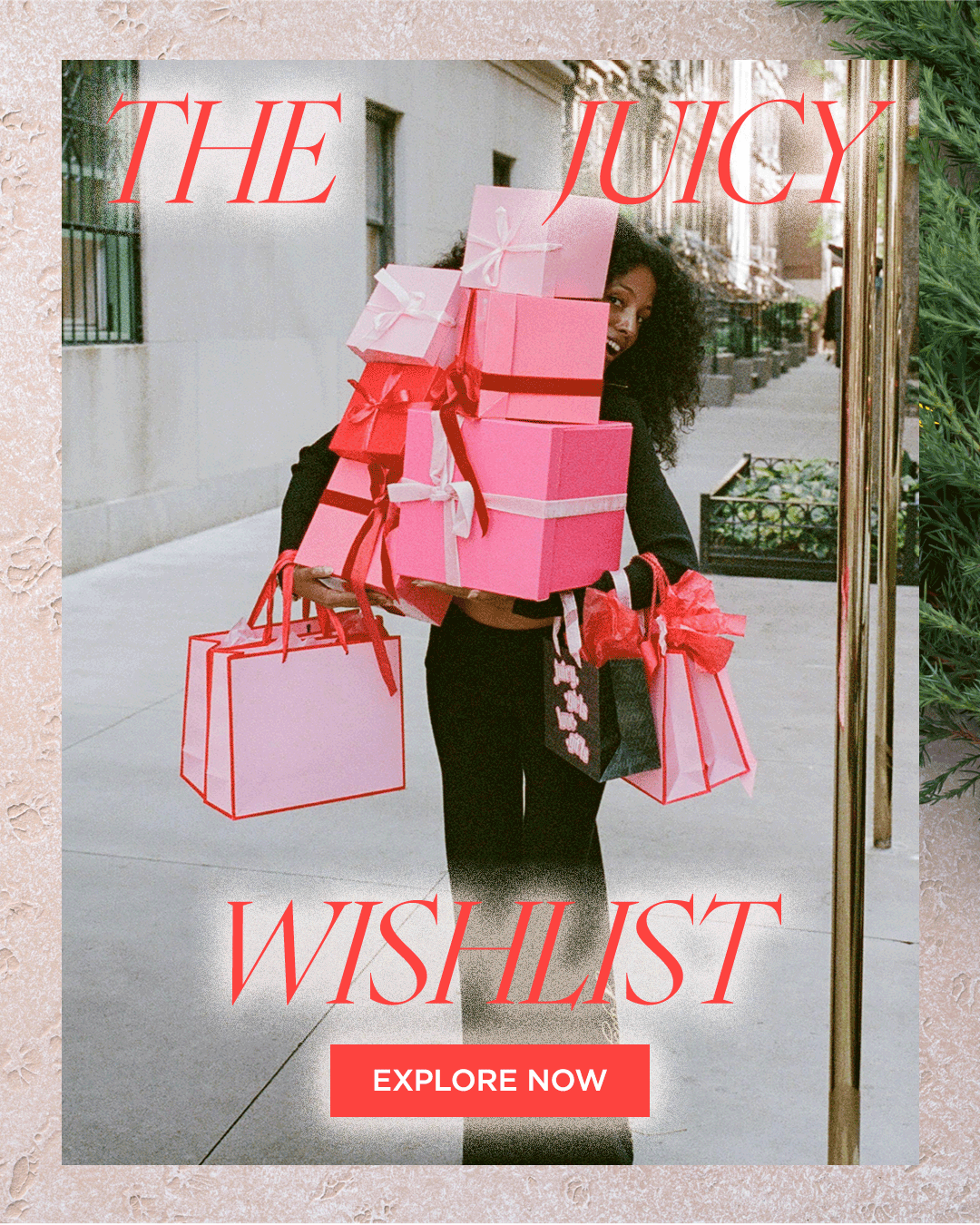 GIF of woman in black tracksuit holding pink and red gift boxes and bags with the text "THE JUICY WISHLIST" and "Explore Now" on top of a pink textured background with a pine branch in the corner.