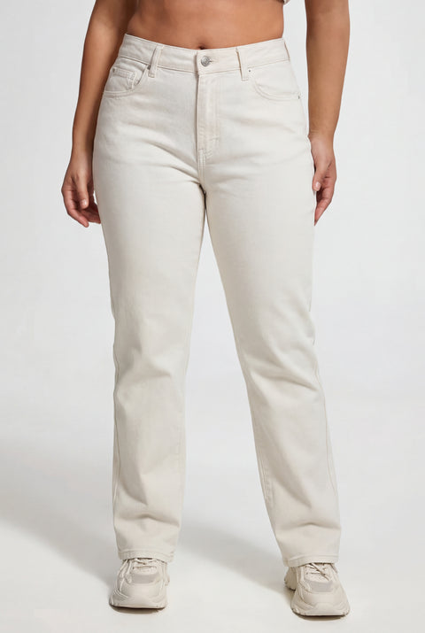 A person wearing White Denim Juicy Couture Jeans—REJUICED, featuring a high-waisted, straight-leg fit with pockets in light beige, paired with white athletic shoes, stands against a plain white background.